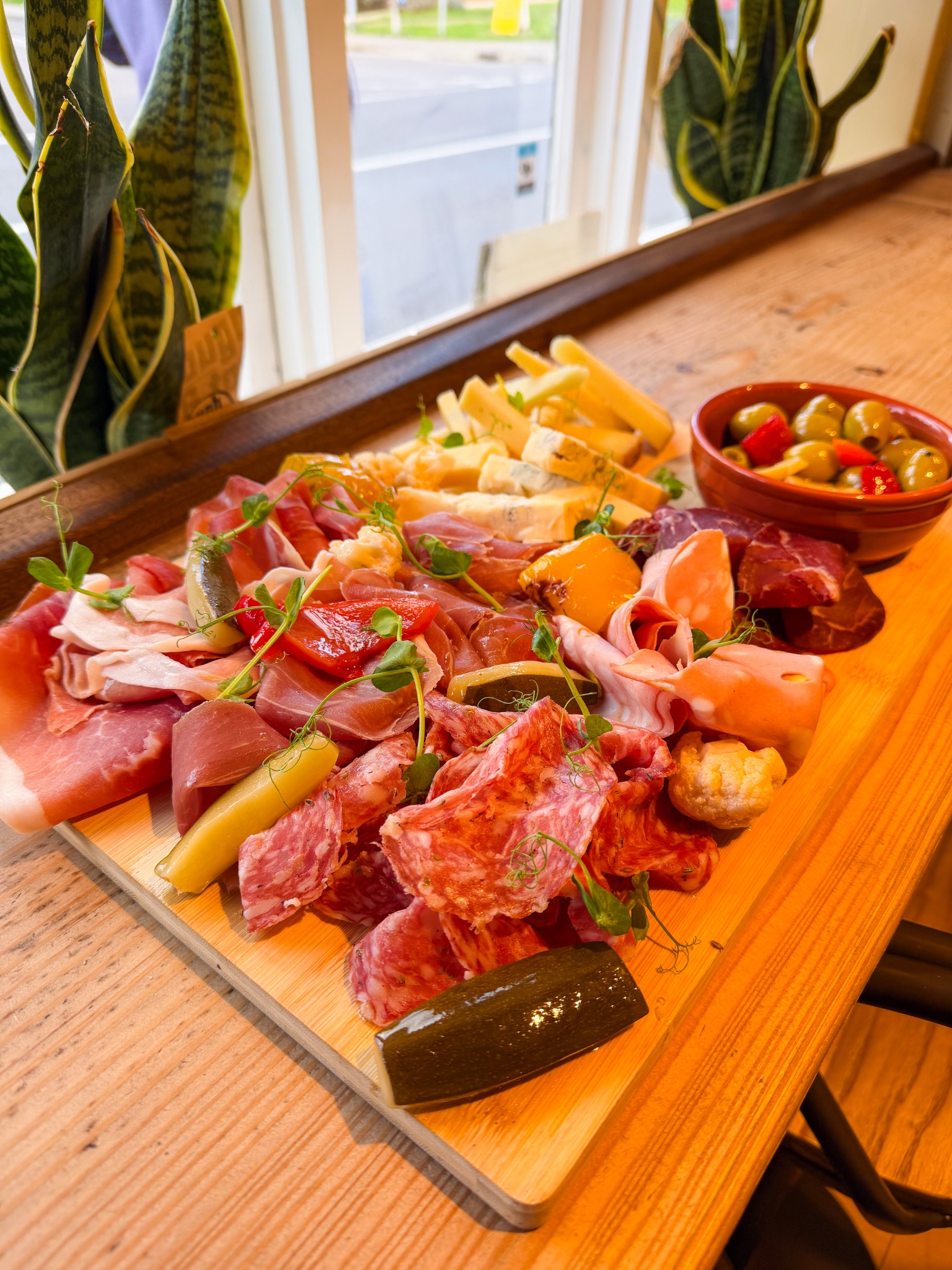 Otto antipasti board with charcuterie, cheese, olives and pickles