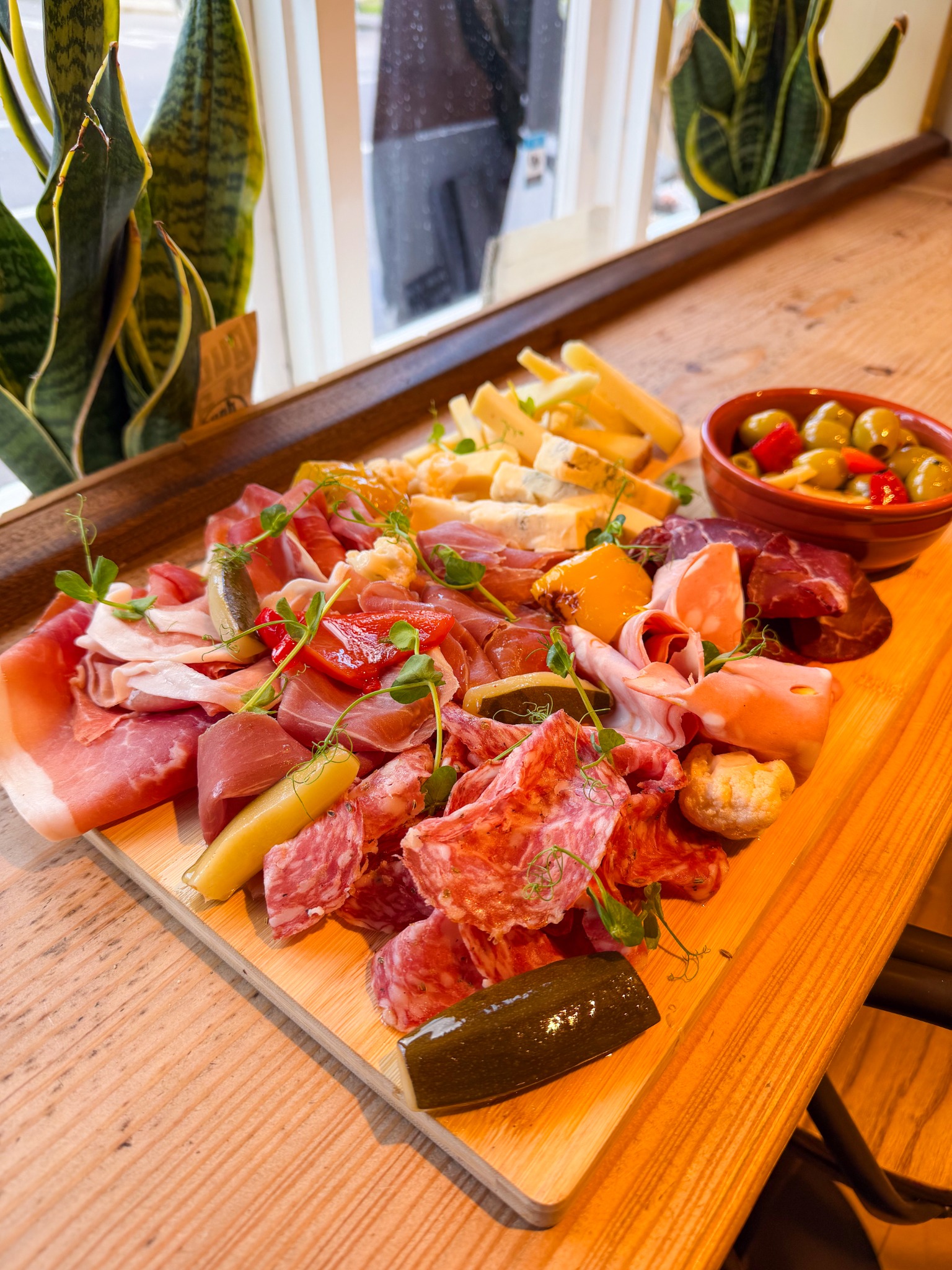 Otto charcuterie and cheese board with olives and pickles