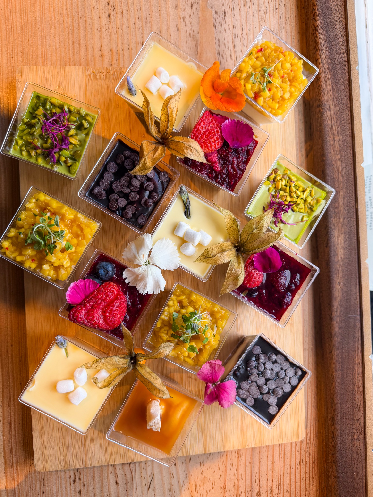 Individual Otto dessert pots arranged on a wooden board