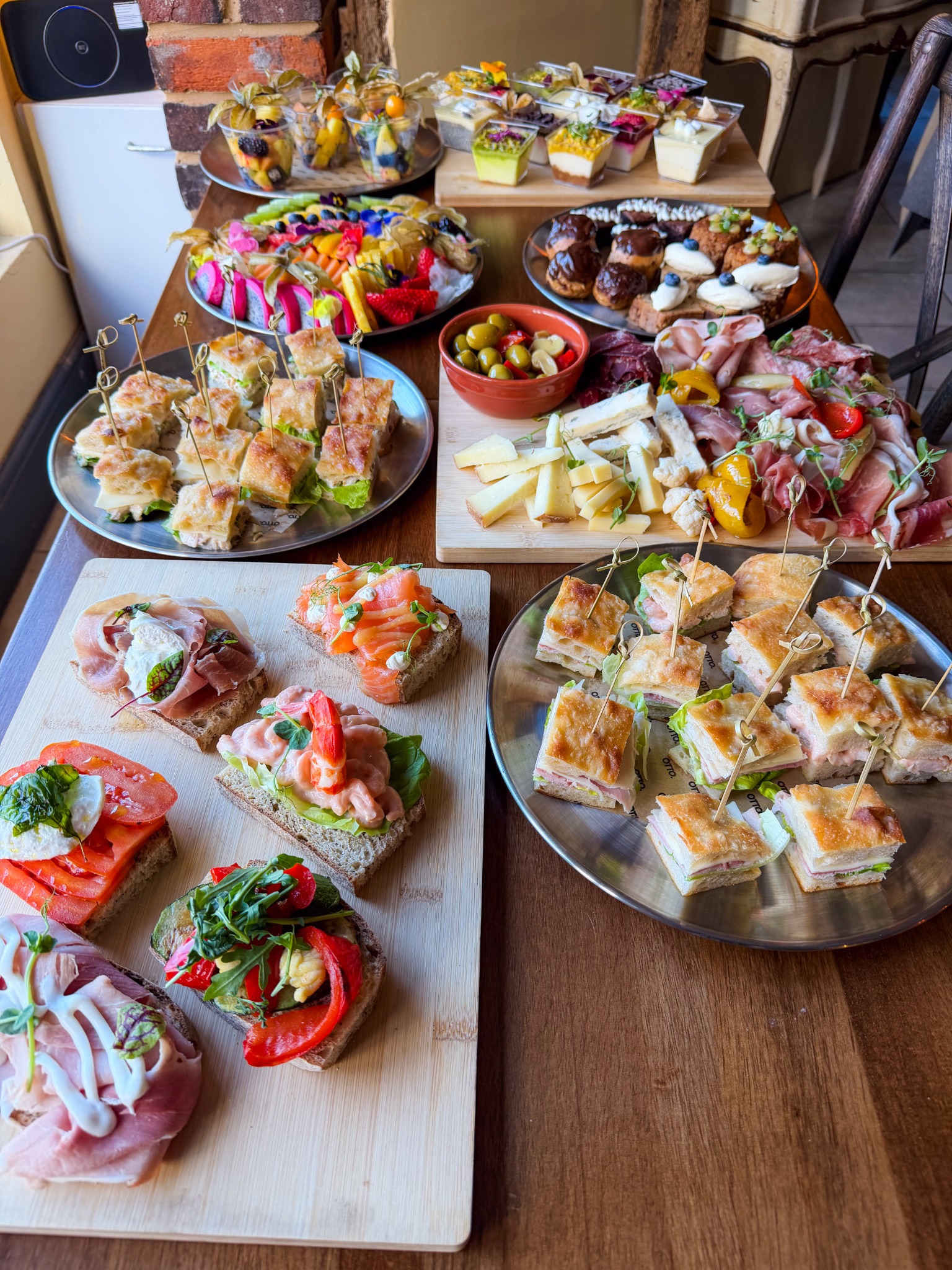 Otto catering spread with open sandwiches, focaccia, sharing boards, fruit and desserts